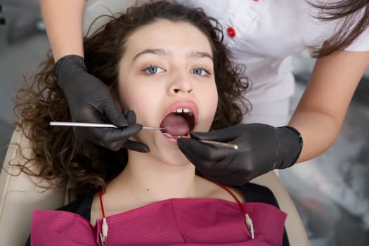 Young Female patient with pretty smile examining dental inspection at dentist clinic. Healthy teeth and medicine, stomatology concept photo