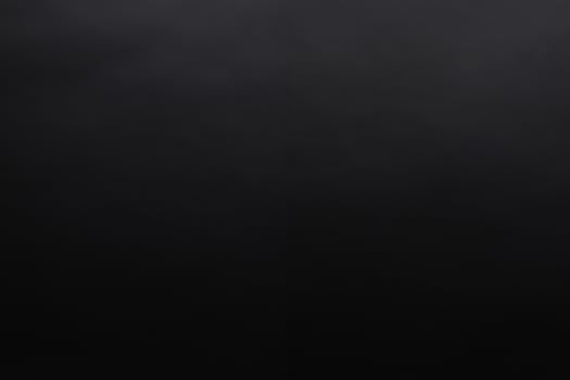 Dark gray texture background with a little light spil photo