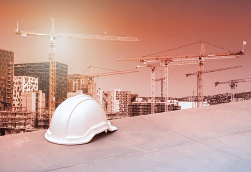 Safety hard helmet for construction engineer and worker on cranes and building background photo