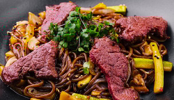 Chinese fried rice with beef on black plate photo