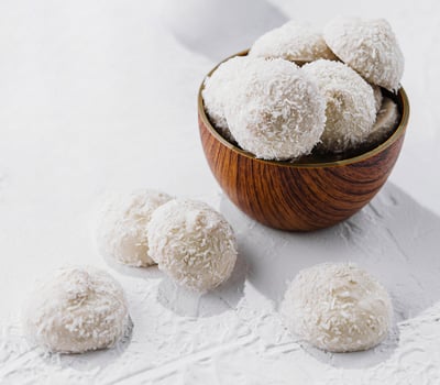 candies in white glaze and coconut flakes photo