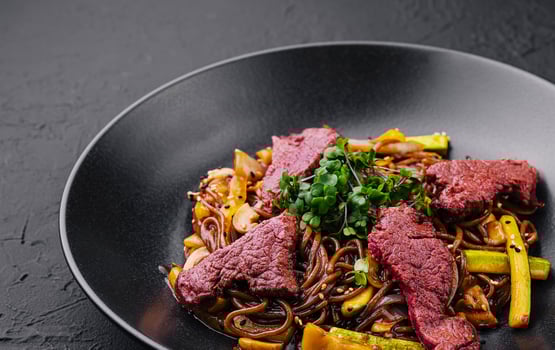 Chinese fried rice with beef on black plate photo