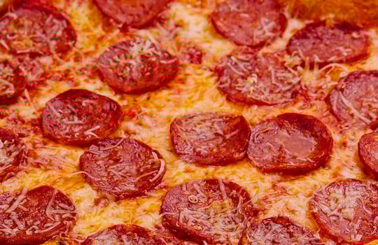 Pizza with pepperoni and parmesan close up photo
