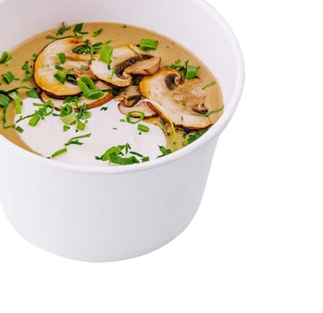 Cream soup with mushrooms isolated on white photo
