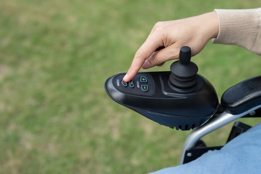 Asian woman patient on electric wheelchair with joystick control at hospital. photo