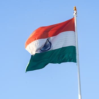 India flag flying high at Connaught Place with pride in blue sky, India flag fluttering, Indian Flag on Independence Day and Republic Day of India, tilt up shot, Waving Indian flag, Har Ghar Tiranga photo