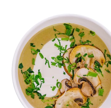 Mushroom cream soup in a bowl isolated on white background photo