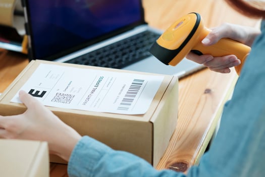 Scanning Barcode on Shipping Box with Scanner photo