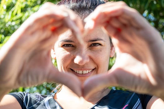 Latin woman making a heart with her hands photo