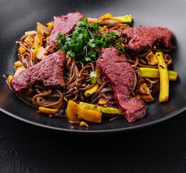 Chinese fried rice with beef on black plate photo