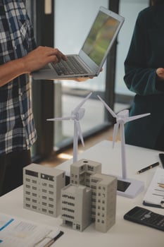 Electrical engineer with businessman discussing new project installation solar cell panel on the roof of building. Alternative energy concept. photo