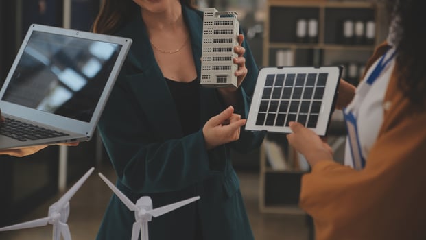 Electrical engineer with businessman discussing new project installation solar cell panel on the roof of building. Alternative energy concept. photo
