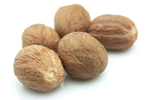 Nutmeg on white backgrounds photo