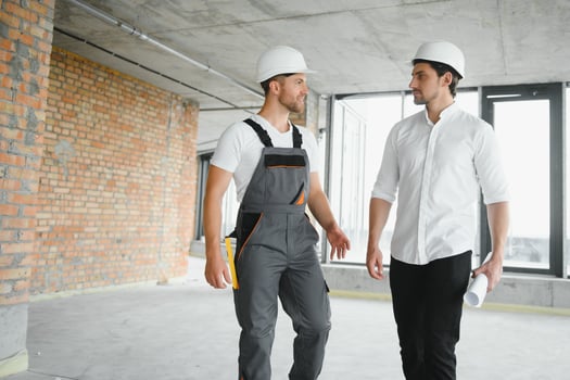 Male Architect Giving Instructions To His Foreman At Construction Site. photo