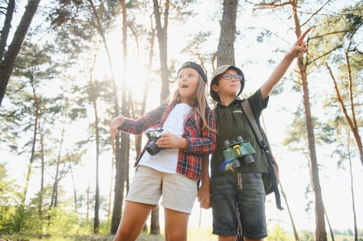 Little boy and girl go hiking on a forest road photo
