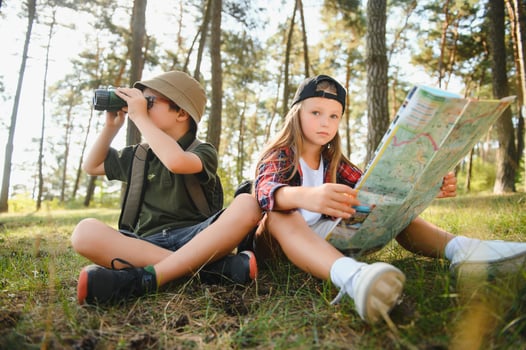 kids in green forest playing,concept of kids vacations and travel photo