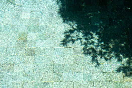 Water surface In swimming pool with sunny reflections and shadows. photo