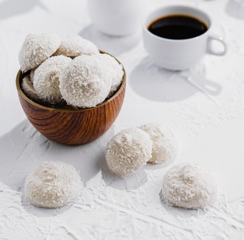 candies in white glaze and coconut flakes photo