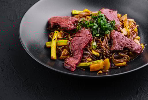 Chinese fried rice with beef on black plate photo