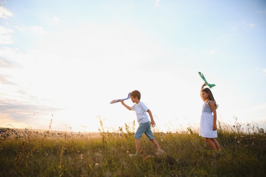 children play toy airplane. concept of happy childhood. children dream of flying and becoming a pilot. photo