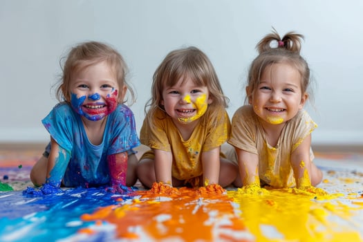 AI generated Small children smeared in paint playing on the floor photo