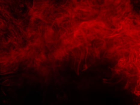 Red smoke texture on black background photo