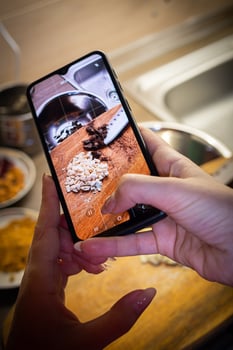 Woman cooking tasty melted chocolate on table in kitchen. photo
