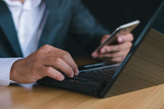 Close up shot Businessman working on laptop, fingers on desk, familiar with work and goals. photo