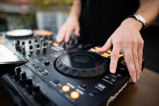 a DJ plays music on a controller at a party photo