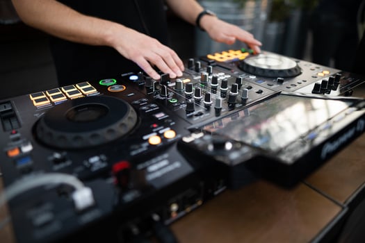 a DJ plays music on a controller at a party photo