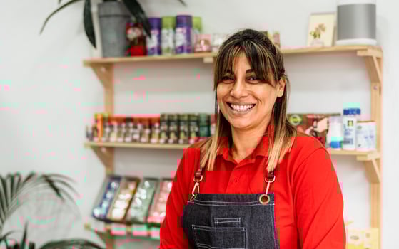 Happy Latin woman working inside supermarket - Retail food concept photo