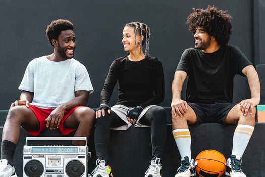 Young multiracial people having fun listening music with vintage boombox outdoor - Urban street people lifestyle photo