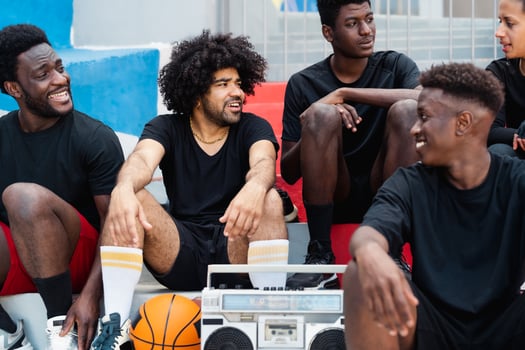 Young multiracial people having fun listening music with vintage boombox outdoor - Urban street people lifestyle photo