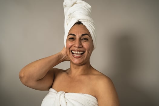 Happy Latin mature woman having skin care spa day - People wellness lifestyle concept photo