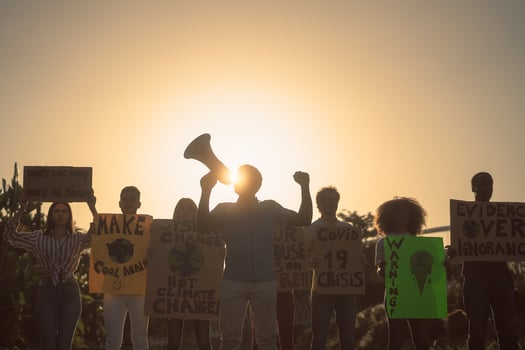 Demonstrators group protesting for climate change - Multiracial people fighting on road holding banners on environments disasters - Global warming concept photo