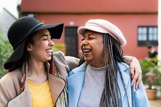 Happy African mother with her daughter having fun in the city - Love and family concept photo