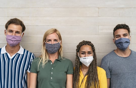 Friends wearing face protective mask to avoid corona virus spread - Young millennial people portrait during coronavirus outbreak - Health care people and youth multiracial lifestyle friendship concept photo