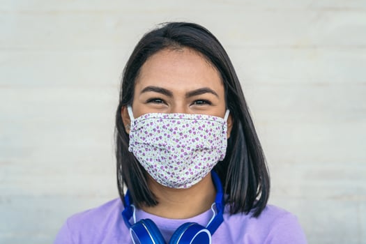 Young woman wearing face mask portrait - Latin girl using protective facemask for preventing spread of corona virus - Health care and pandemic crisis concept photo