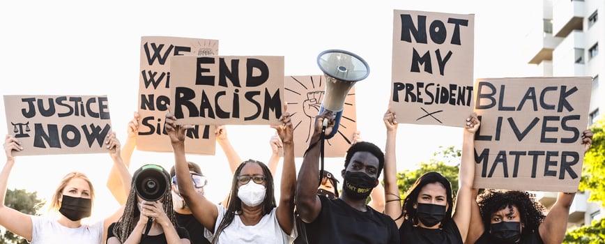 Activist movement protesting against racism and fighting for equality - Demonstrators from different cultures and race protest on street for equal rights - Black lives matter protests city concept photo