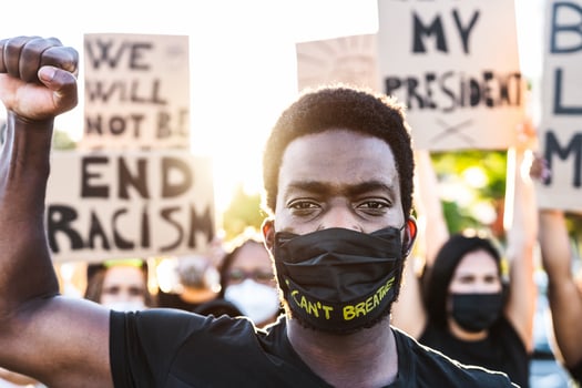 Black lives matter activist movement protesting against racism and fighting for equality - Demonstrators from different cultures and race protest on street for justice and equal rights photo