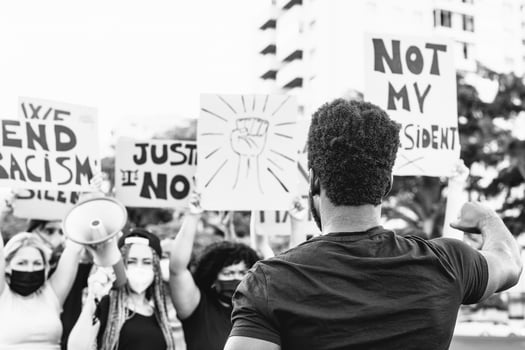 Black lives matter activist movement protesting against racism and fighting for equality - Demonstrators from different cultures and race protest on street for justice and equal rights photo