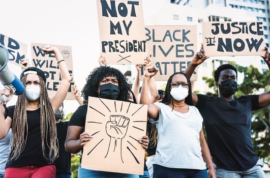 Black lives matter activist movement protesting against racism and fighting for equality - Demonstrators from different cultures and race protest on street for justice and equal rights photo