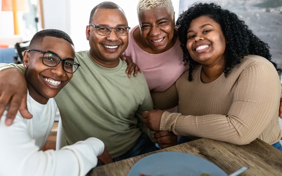 Happy African family having fun after a lunch together at home photo
