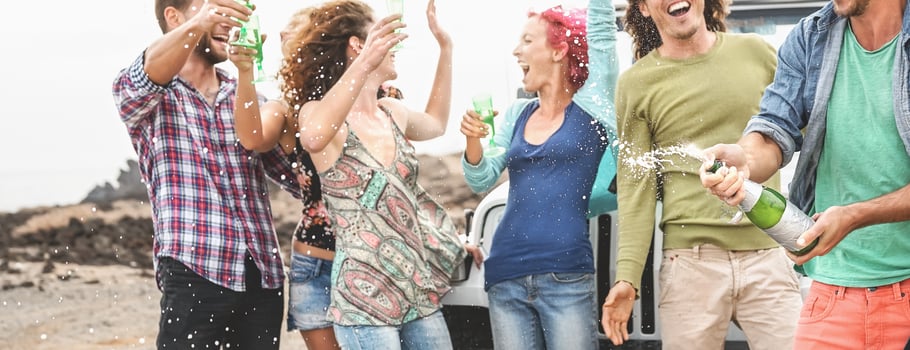 Group happy friends celebrating with champagne outdoor - Young people having fun drinking white wine during road trip vacation - Youth culture holidays lifestyle concept photo
