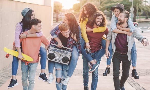 Happy friends having fun walking piggyback in the city center. Group young people laughing and sharing time together outdoor. Youth culture  friendship people lifestyle concept photo