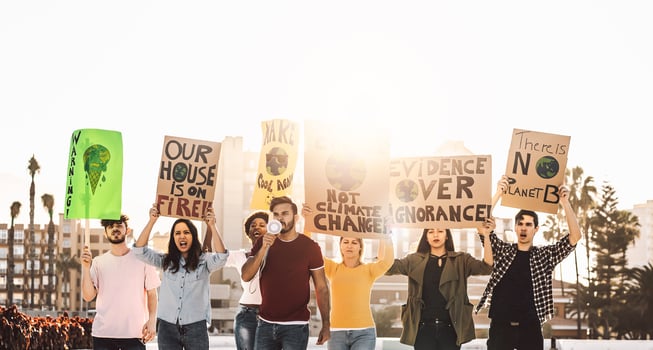 Demonstrators group protesting against plastic pollution and climate change - Multiracial people fighting on road holding banners on environments disasters - Global warming concept photo
