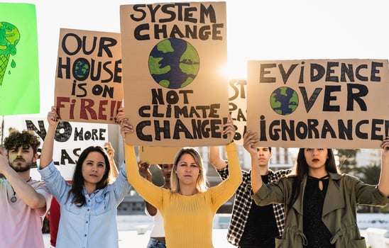 Group of young and diverse activists protesting for climate change - Global warming concept photo