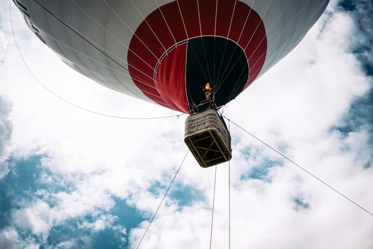 Happy people flying on big balloon airship - Tourists having fun during a flying excursion - Travel lifestyle, tourism and vacation concept photo