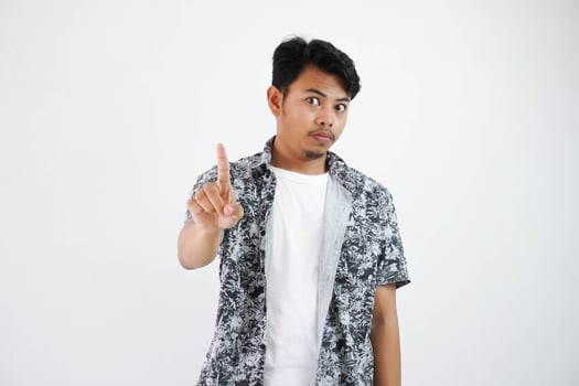 Positive young asian man wearing black shirt confident show finger up isolated on white background photo