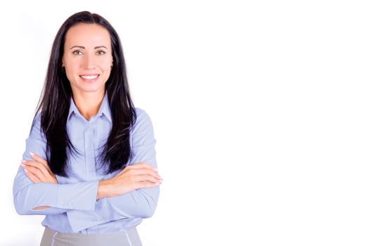 Portrait of a smiling, young attractive business woman in a blue shirt with her arms crossed. Business lady photo